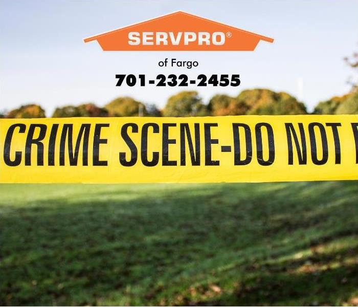 Yellow crime scene tape delineates an active crime scene investigation.
